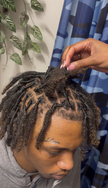 Freshly retwisted locs styled at the front