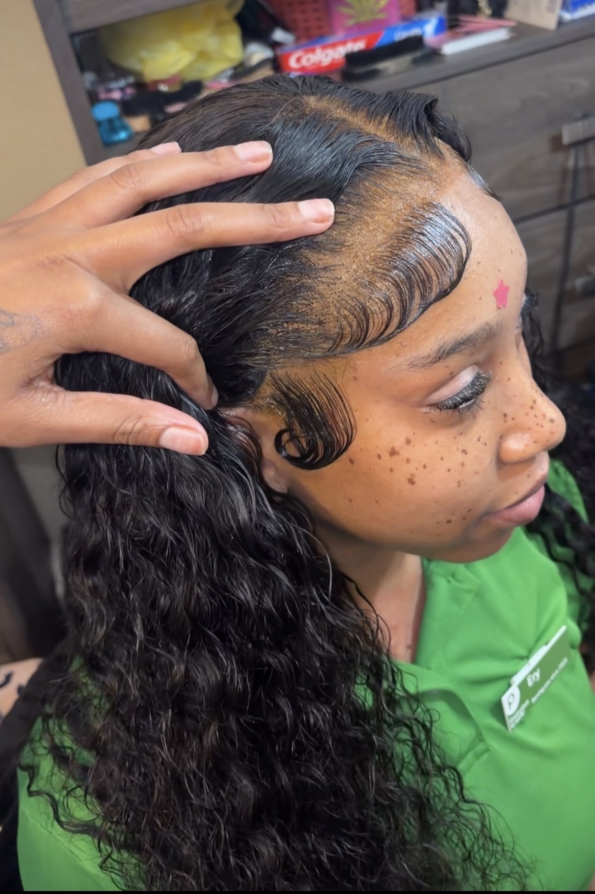 Freshly installed curly frontal with laid baby hairs on a client