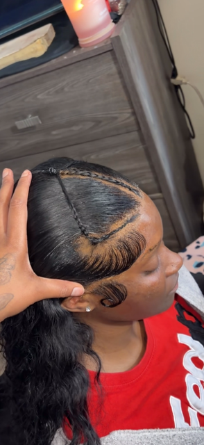 Sleek frontal install with braided detail and swooped baby hairs